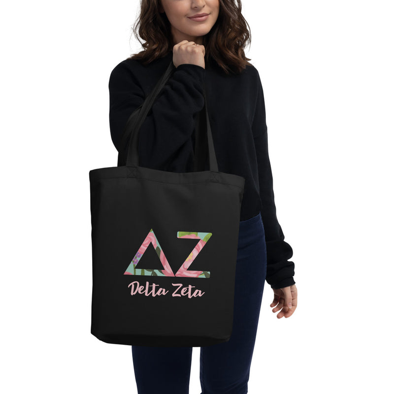 Delta Zeta Sorority Tote Bag with filled letters and sorority name on black bag on model&