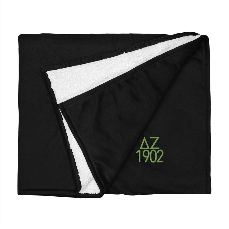 Delta Zeta Sorority Blanket in black with green embroidery shown flat