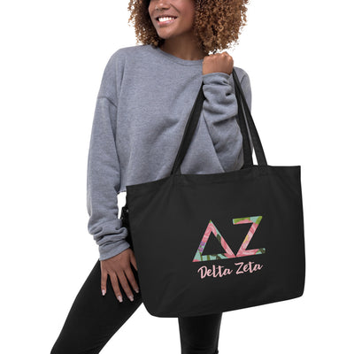 Delta Zeta Sorority Tote Bag in black printed with filled letters and sorority name shown on model's arm