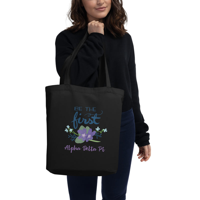 Alpha Delta Pi Be The First Eco Tote Bag shown in black on woman&