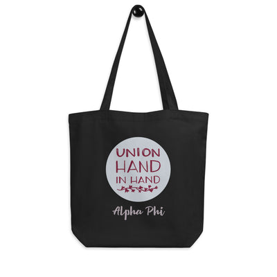 Alpha Phi Union Hand in Hand Eco Tote Bag shown on a hook