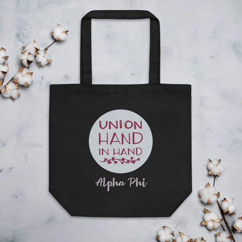 Alpha Phi Union Hand in Hand Eco Tote Bag shown flat with cotton flowers