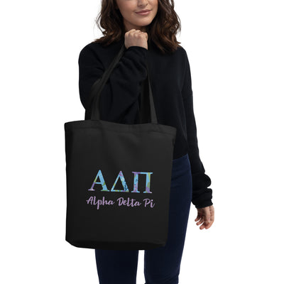 Alpha Delta Pi Greek Letters Eco Tote Bag shown in black on woman's arm