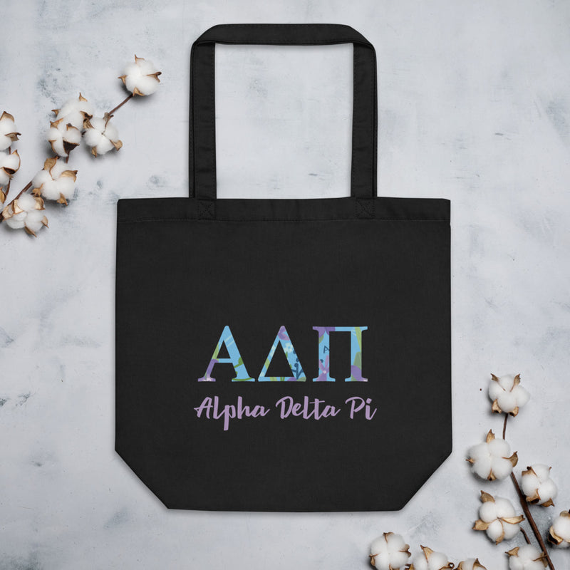 Alpha Delta Pi Greek Letters Eco Tote Bag shown in black with cotton blossoms