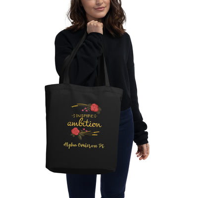 Alpha Omicron Pi Inspire Ambition Eco Tote Bag in black on model's arm