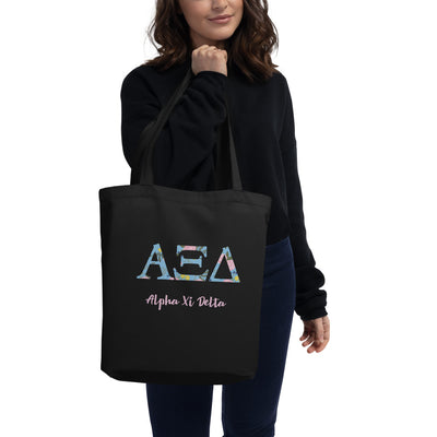 Alpha Xi Delta Greek Letters Eco Tote Bag in black on model's arm