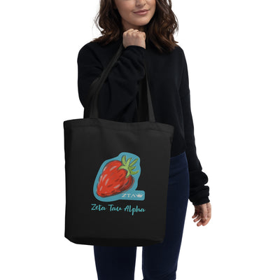 Zeta Tau Alpha Strawberry Eco Tote Bag in black shown on woman's arm