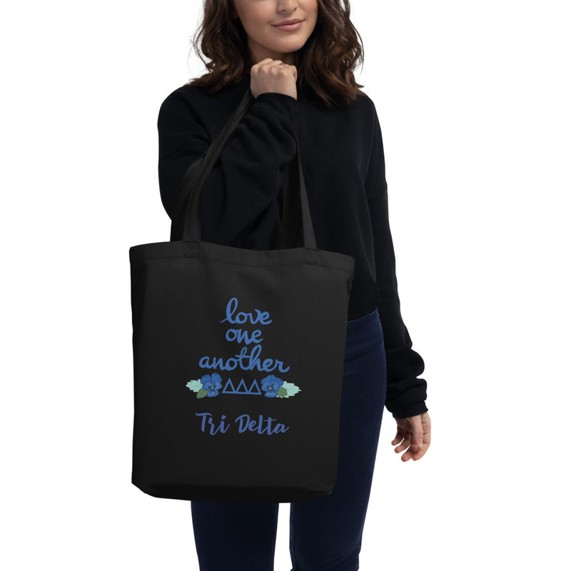 Tri Delta Love One Another Eco Tote Bag shown in black on model 