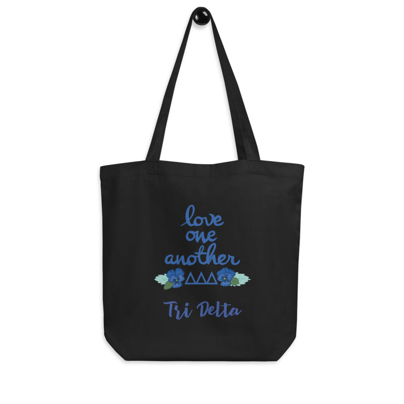 Tri Delta Love One Another Eco Tote Bag in black shown on hook