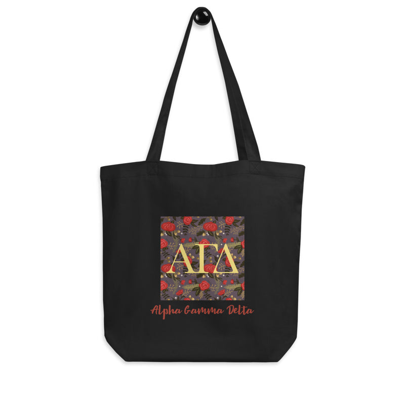 Alpha Gamma Delta Greek Letters Eco Tote Bag in black shown on hook