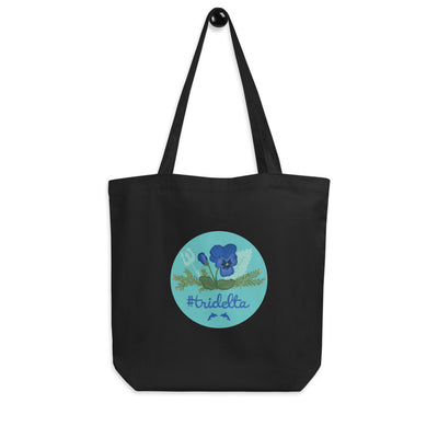 Tri Delta Pansy and Poseidon Eco Tote Bag in black shown on a hook