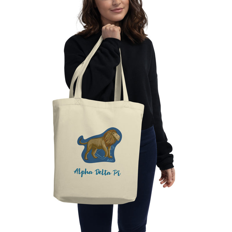 Alpha Delta Pi Alphie the Lion Eco Tote Bag shown in natural oyster color on woman&