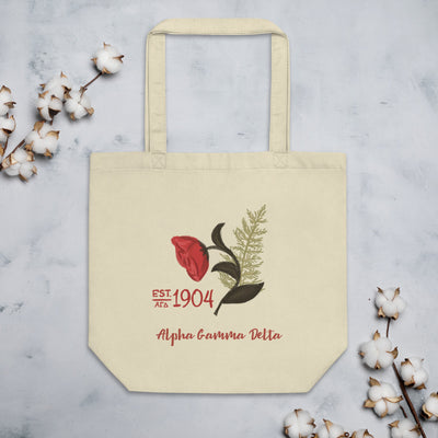 Alpha Gamma Delta Founders Day Eco Tote Bag in oyster shown with cotton blossoms
