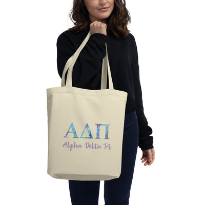 Alpha Delta Pi Greek Letters Eco Tote Bag shown in natural oyster color on woman's arm