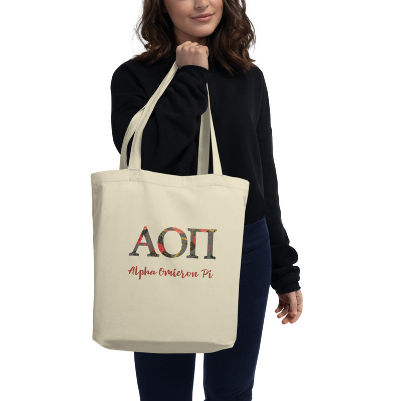 Alpha Omicron Pi Greek Letters Eco Tote Bag in natural oyster color shown on model&