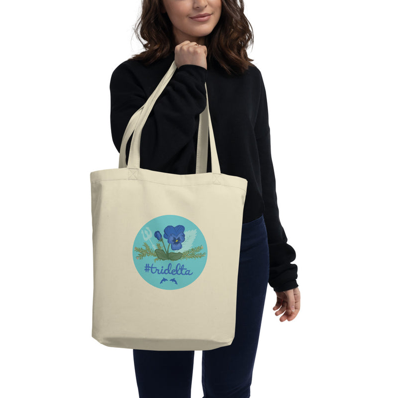 Tri Delta Pansy and Poseidon Eco Tote Bag in natural oyster shown on model