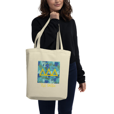 Tri Delta Greek Letters Eco Tote Bag shown in natural oyster on a model's arm