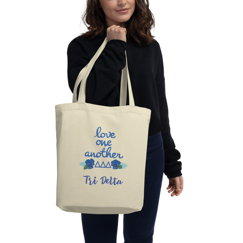 Tri Delta Love One Another Eco Tote Bag shown in natural oyster on model