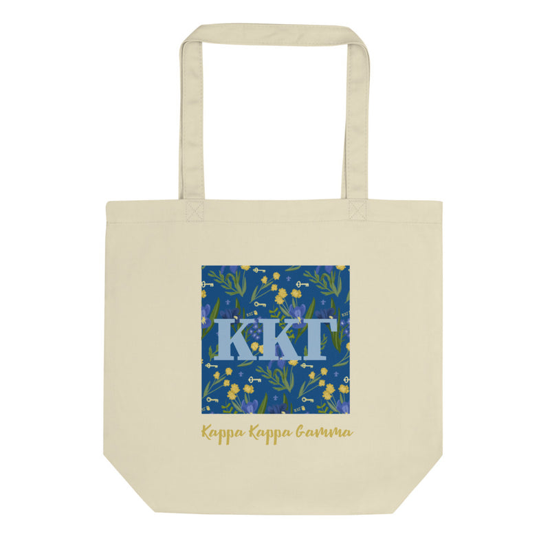 Kappa Kappa Gamma Greek Letters with a blue iris pattern behind. Printed on a natural canvas shopping tote.