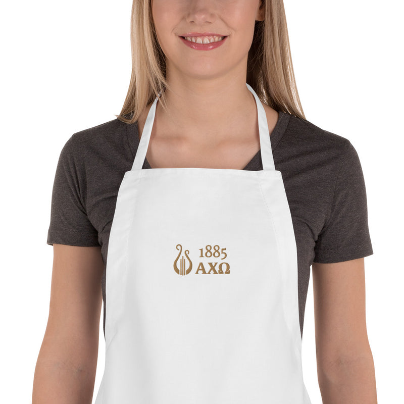 Alpha Chi Omega 1885 Lyre Embroidered Apron with close up on a young woman