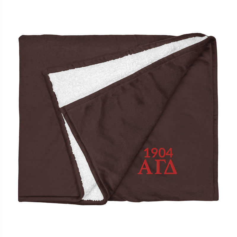 Alpha Gamma Delta Plush Embroidered Sherpa Blanket in brown flat