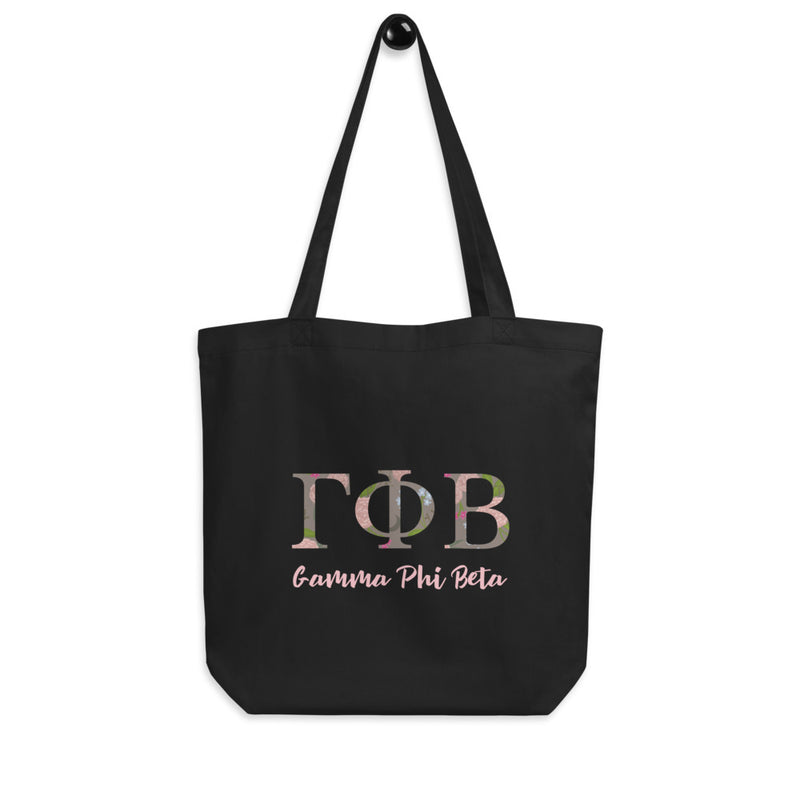 Gamma Phi Beta Sorority Letters Tote Bag in black shown hanging on a hook