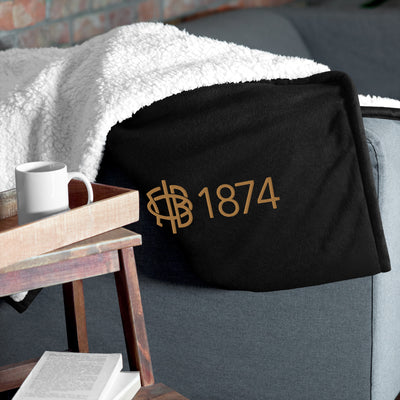 Gamma Phi Beta Plus Embroidered Sherpa Blanket in black on couch