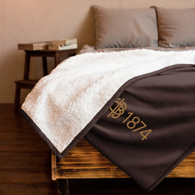 Gamma Phi Beta Plus Embroidered Sherpa Blanket in brown on bed