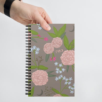 Gamma Phi Beta Pink Carnation Print Spiral Notebook in person's hand