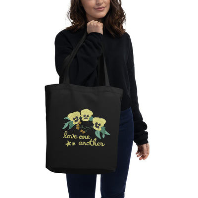 Kappa Alpha Theta Love One Another Eco Tote Bag in black on model's arm