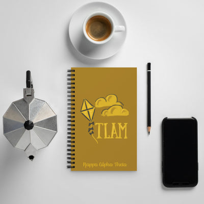 Kappa Alpha Theta TLAM Spiral Notebook shown with coffee