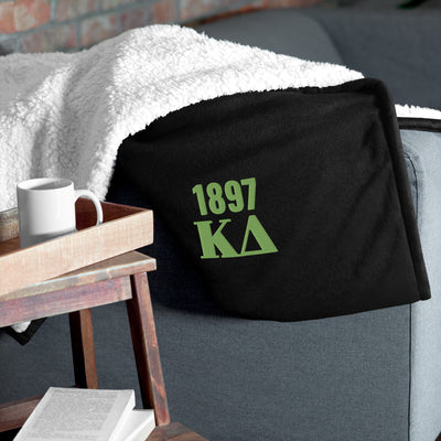 Kappa Delta Plush Embroidered Sherpa Blanket in black on couch