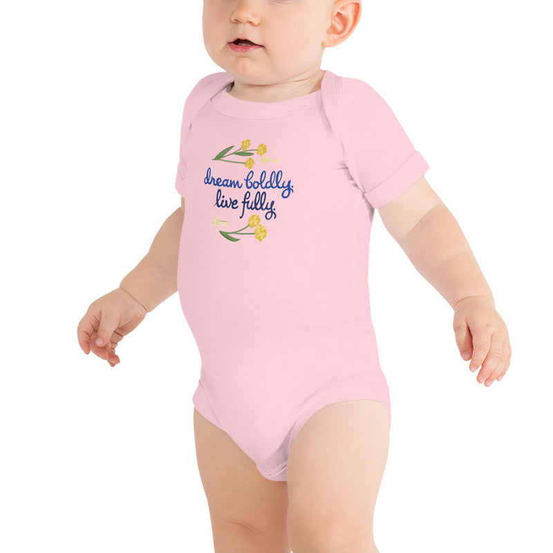Kappa Kappa Gamma Dream Boldly. Live Fully Baby Onesie in pink on toddler showing artist-drawn motto design.