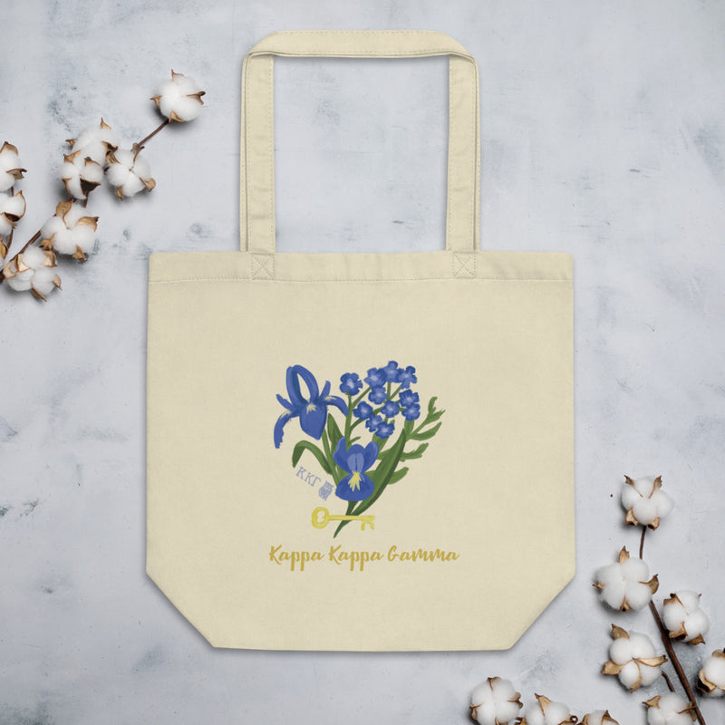Kappa Kappa Gamma Fleur de Key design on a natural oyster color organic cotton tote bag shown flat with cotton blossoms