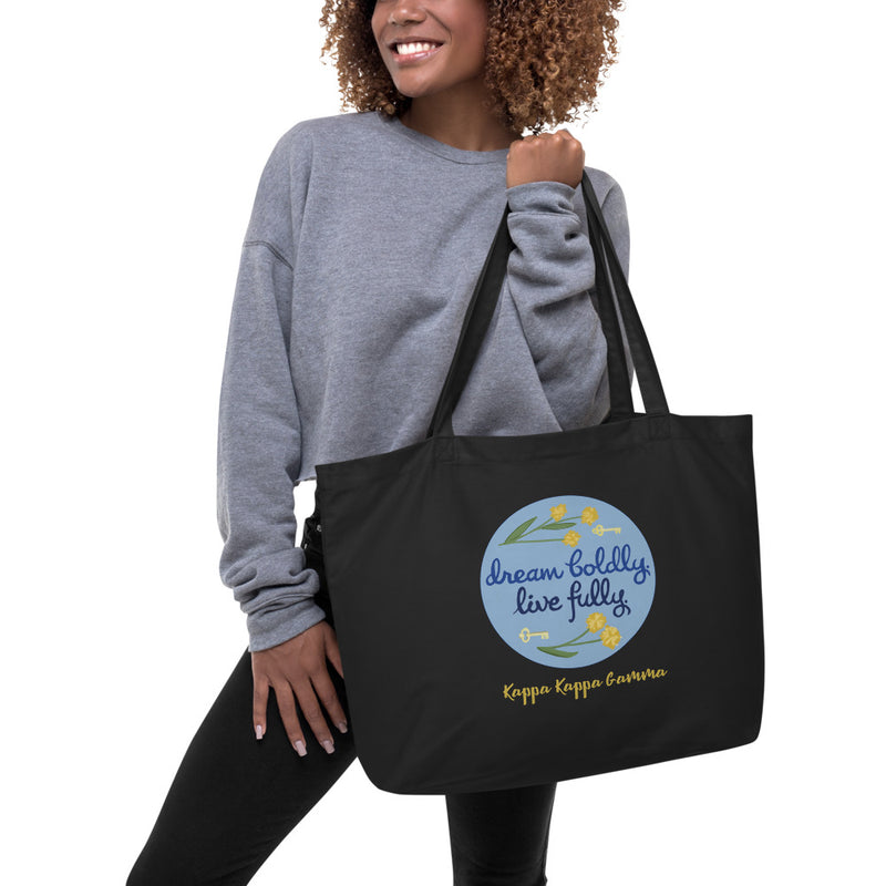 Kappa Kappa Gamma Sorority Motto Dream Boldly. Live Fully. printed on black canvas shopping tote shown on model&