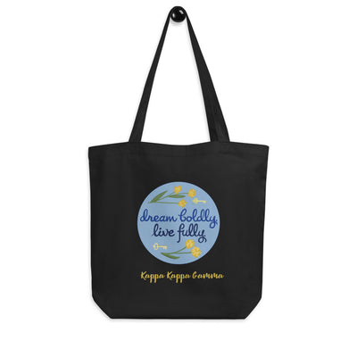 Kappa Kappa Gamma Dream Boldly. Live Fully. motto printed on a black canvas bag shown hanging up on a hook.