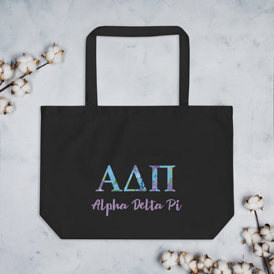 Alpha Delta Pi Greek Letters Large Organic Tote Bag in black shown flat with cotton blossoms