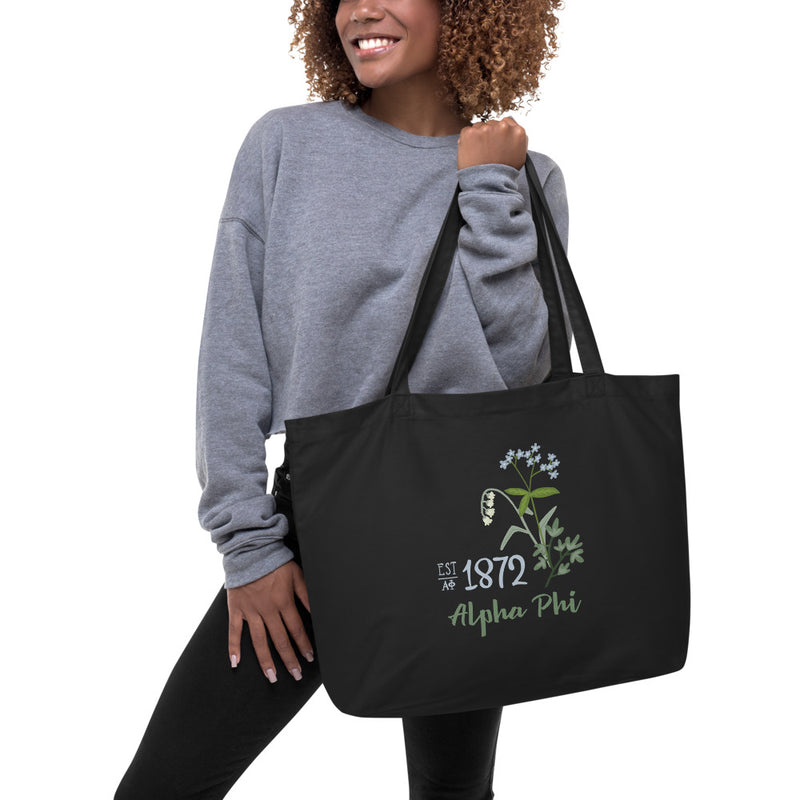Alpha Phi 1872 Founders Day Design Large Organic Eco Tote Bag in black shown with model