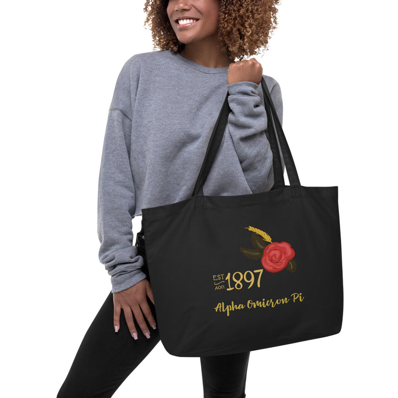 Alpha Omicron Pi 1897 Founders Day Large Organic Tote Bag in black shown on model&