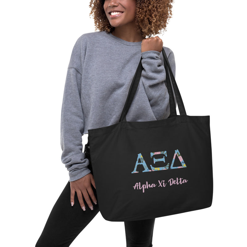 Alpha Xi Delta Greek Letters Large Organic Tote Bag in black shown on model&