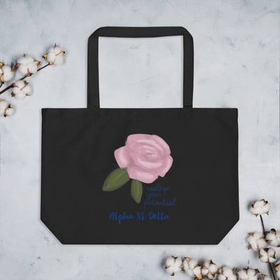 Alpha Xi Delta Realize Your Potential Large Organic Eco Tote Bag in black shown flat with cotton