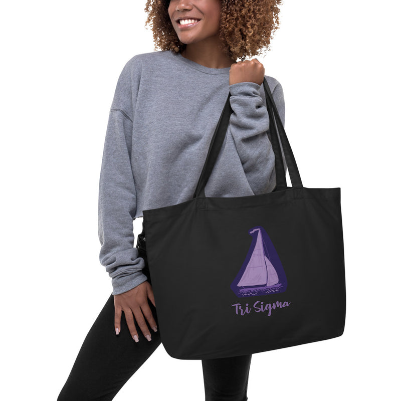 Tri Sigma Sailboat Mascot Large Organic Tote Bag in black on model