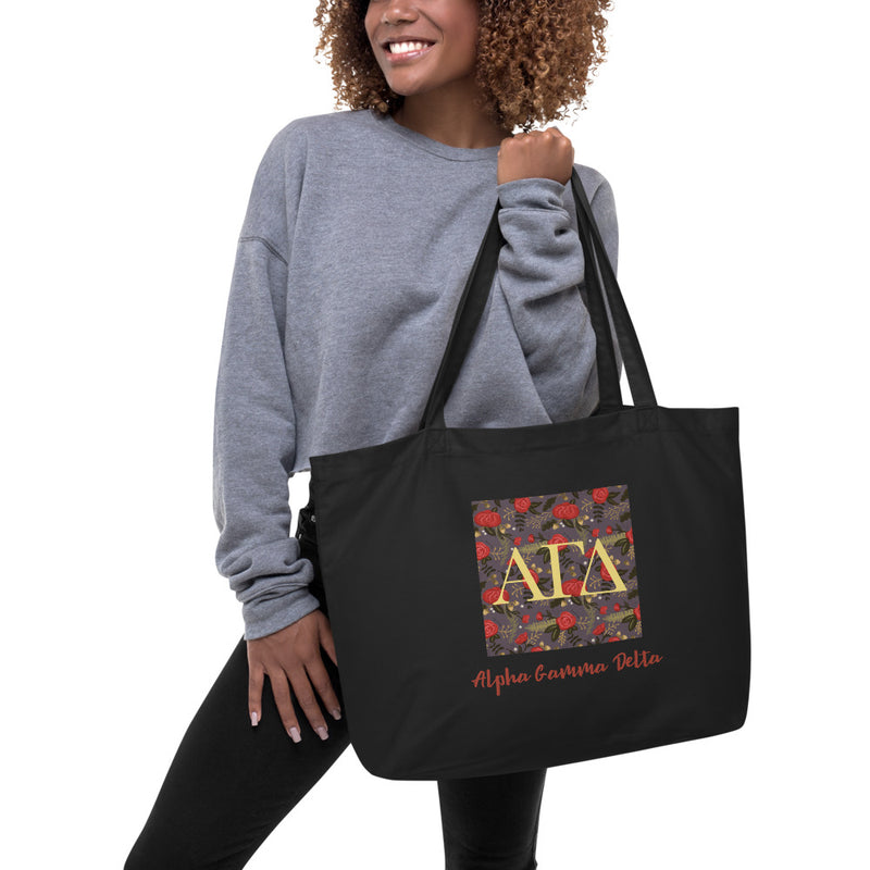 Alpha Gamma Delta Greek Letters Large Organic Tote Bag in black on woman&