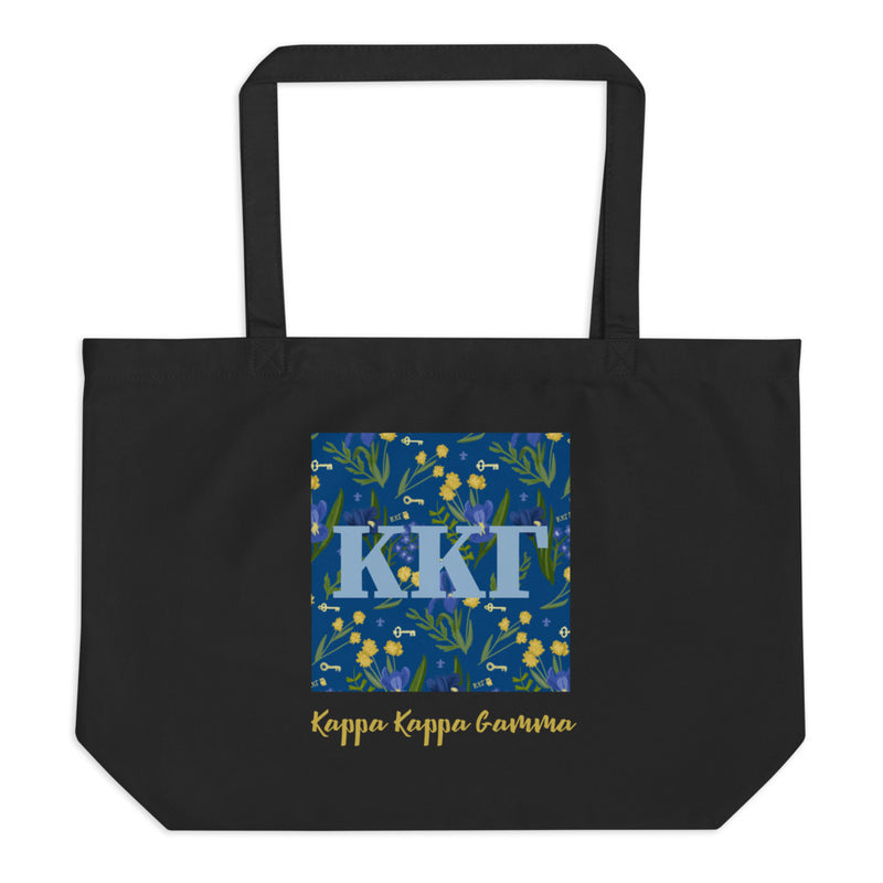 Kappa Kappa Gamma Greek Letters surrounded with a blue iris and key print printed on a black canvas shopping tote.