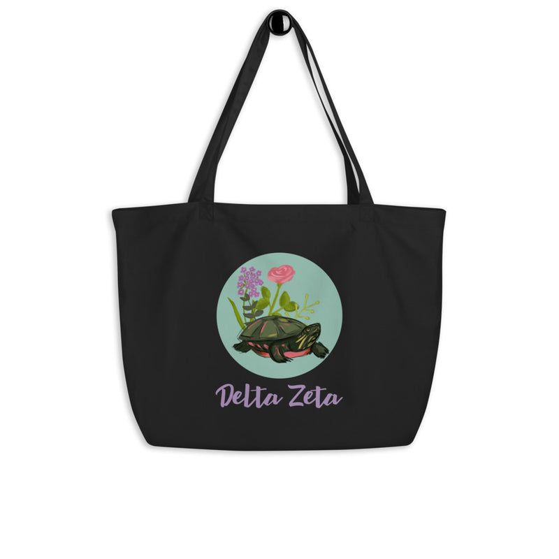 Delta Zeta Tortoise Mascot Large Organic Tote Bag shown in black on hook