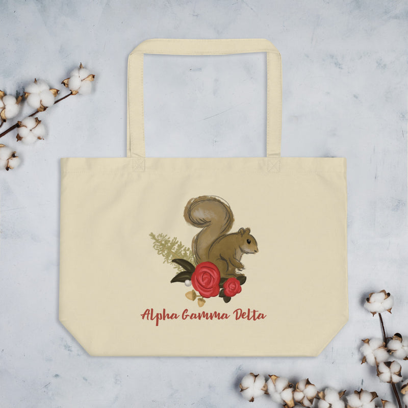 Alpha Gamma Delta Squirrel Mascot Large Organic Eco Tote Bag shown in natural oyster color with cotton blossoms