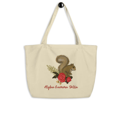 Alpha Gamma Delta Squirrel Mascot Large Organic Eco Tote Bag shown in natural oyster color on a hook