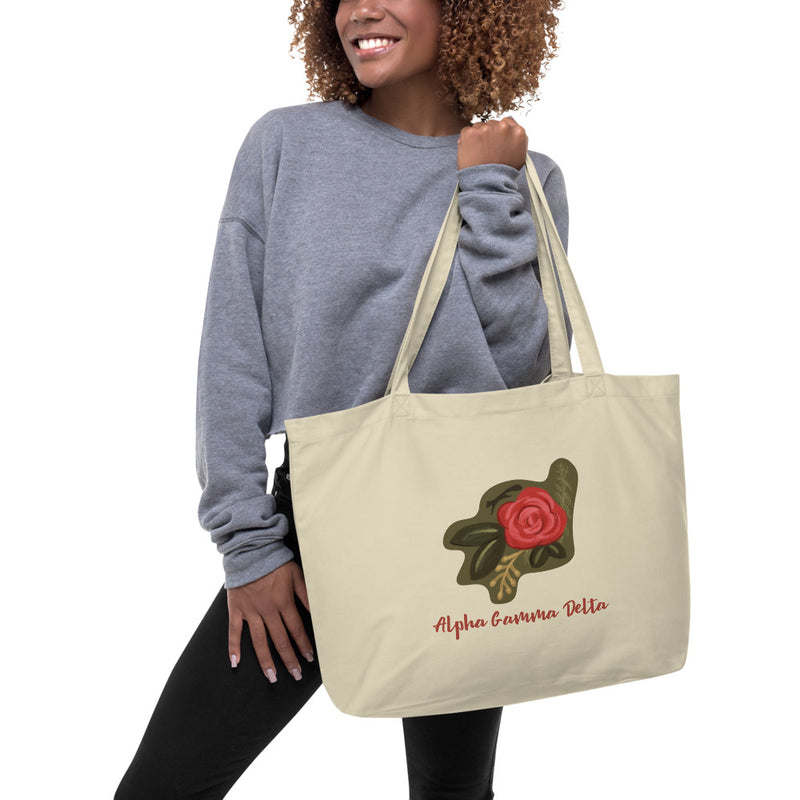 Alpha Gamma Delta Red Rose Large Organic Tote Bag in oyster shown on woman&