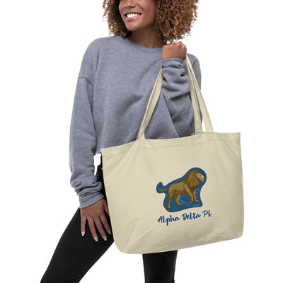 Alpha Delta Pi Alphie The Lion Large Organic Tote Bag shown in natural oyster on woman's arm