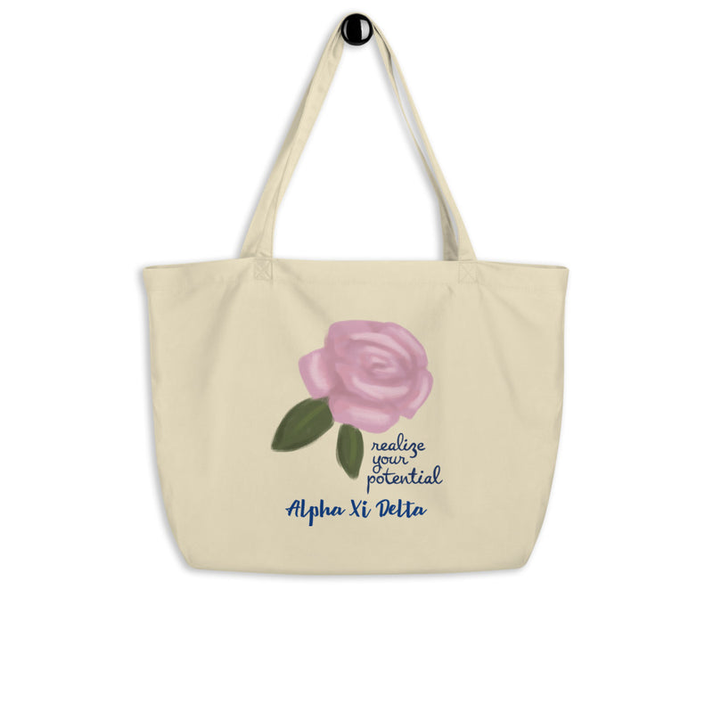 Alpha Xi Delta Realize Your Potential Large Organic Eco Tote Bag shown on a hook